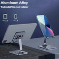 Plyzo adjustable aluminum phone and tablet stand holding a device at an angle on a desk